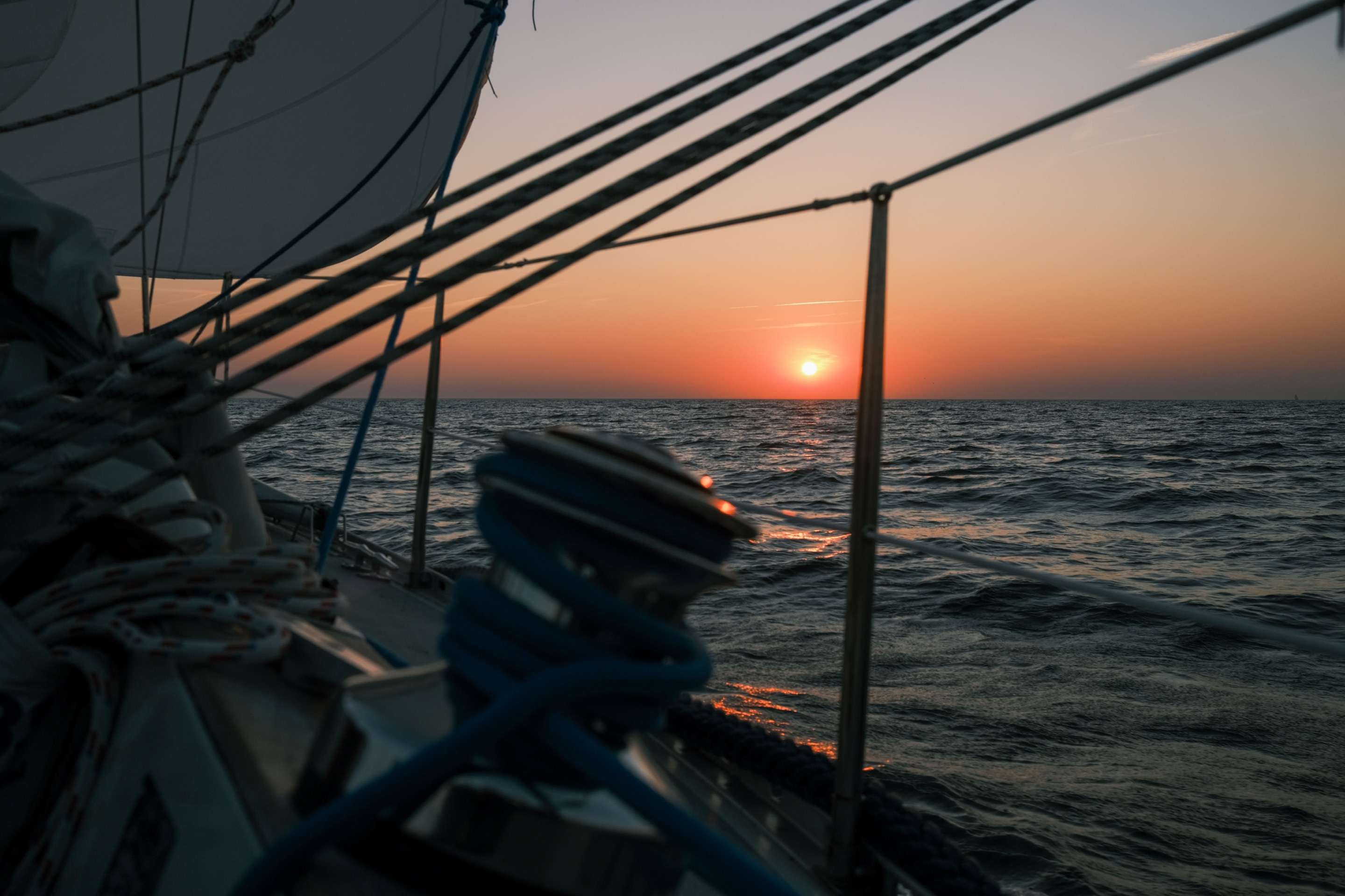 Sailing vessel at sunset on the sea